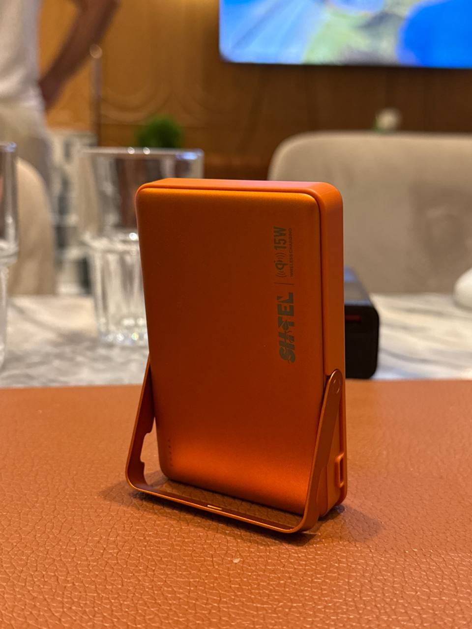 Orange SHTEL SP-80 magnetic wireless power bank with built-in stand